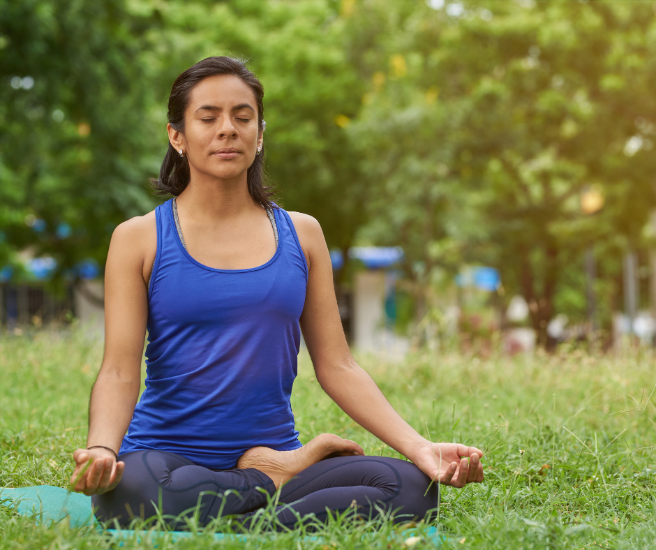 Woman practicing yoga in park